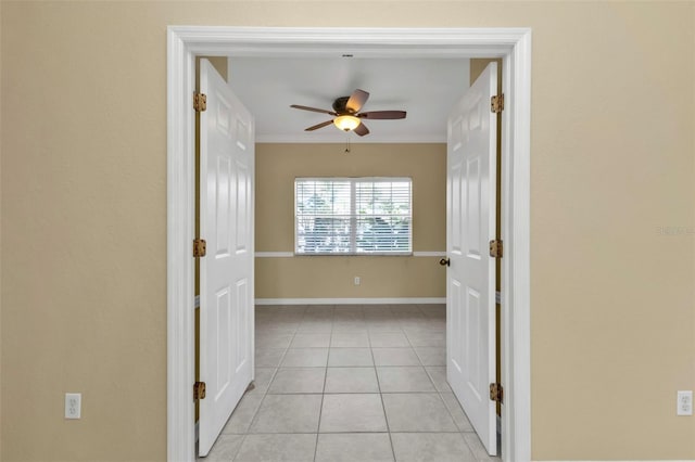 hall featuring ornamental molding and light tile patterned floors