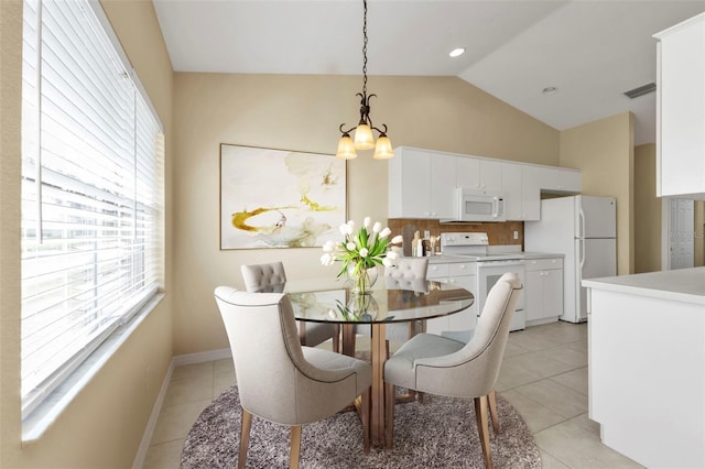 dining area with light tile patterned flooring, vaulted ceiling, and a notable chandelier