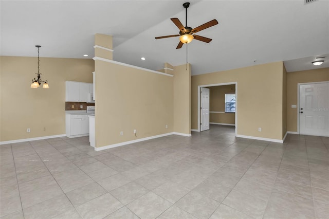 unfurnished living room featuring ceiling fan with notable chandelier, light tile patterned floors, and high vaulted ceiling