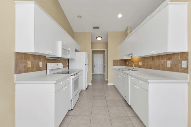 kitchen featuring white appliances, white cabinets, sink, decorative backsplash, and light tile patterned floors