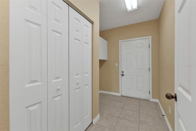 doorway with light tile patterned flooring