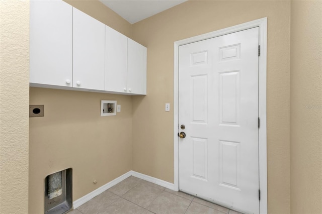 clothes washing area featuring hookup for an electric dryer, washer hookup, cabinets, light tile patterned floors, and hookup for a gas dryer