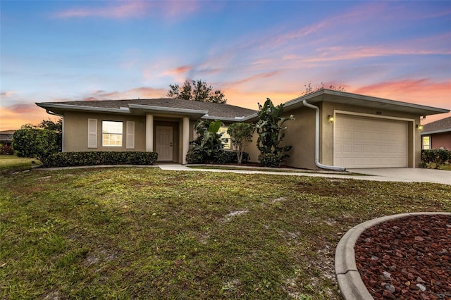 view of front of house with a garage and a yard