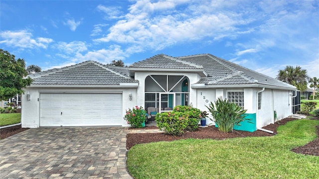 view of front of home featuring a garage and a front lawn