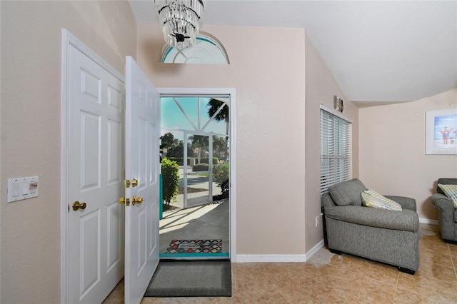 entryway featuring light tile patterned flooring and an inviting chandelier