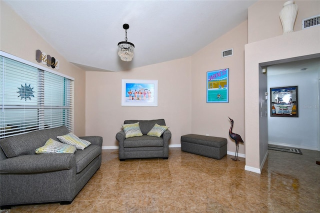 living room with light tile patterned floors and vaulted ceiling