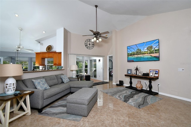 tiled living room with ceiling fan, high vaulted ceiling, and a healthy amount of sunlight