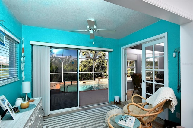 doorway with light carpet, a wealth of natural light, and ceiling fan