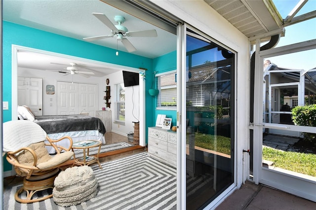 bedroom featuring ceiling fan, access to exterior, and a closet