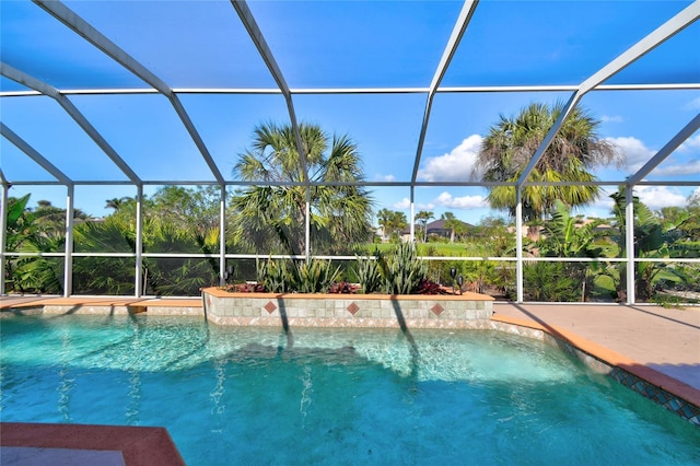 view of swimming pool featuring glass enclosure and pool water feature