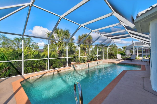 view of swimming pool featuring glass enclosure and a patio area