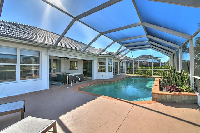 view of pool featuring ceiling fan, a lanai, and a patio