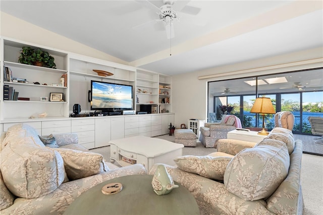 carpeted living room with vaulted ceiling and ceiling fan