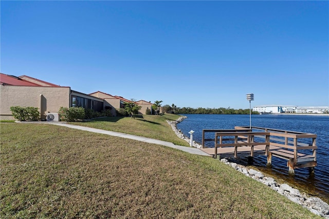 dock area featuring a lawn and a water view