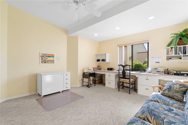 carpeted office with ceiling fan and built in desk