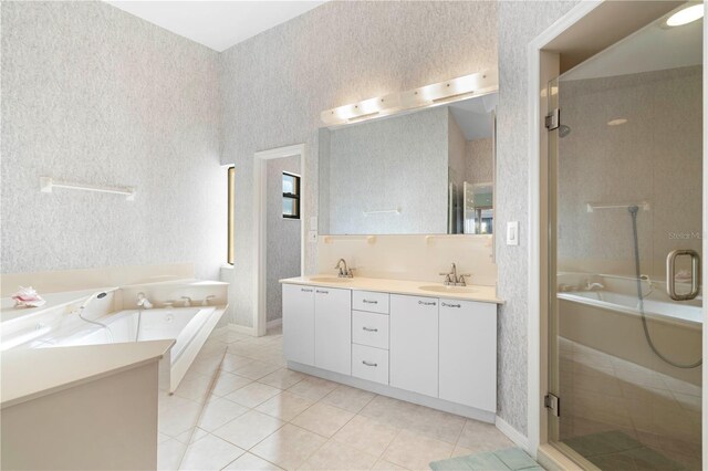 bathroom featuring tile patterned floors, vanity, and shower with separate bathtub