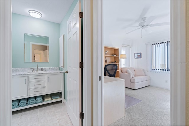 hallway with light colored carpet and sink