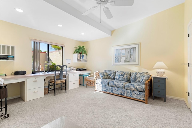 carpeted home office featuring built in desk and ceiling fan