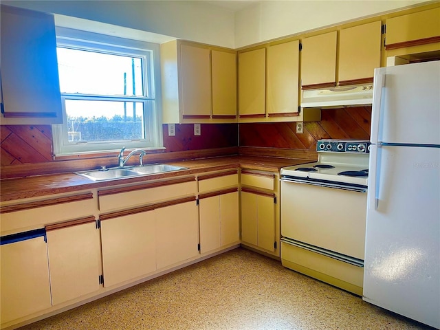 kitchen featuring wood counters, sink, white appliances, and cream cabinetry