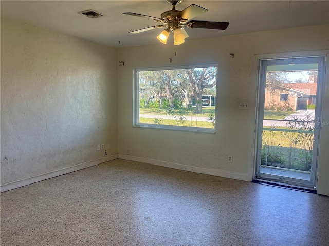 unfurnished room featuring a wealth of natural light and ceiling fan