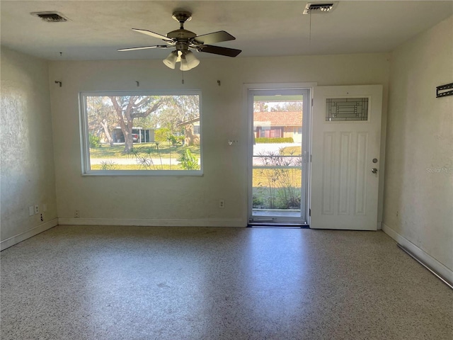 interior space with ceiling fan