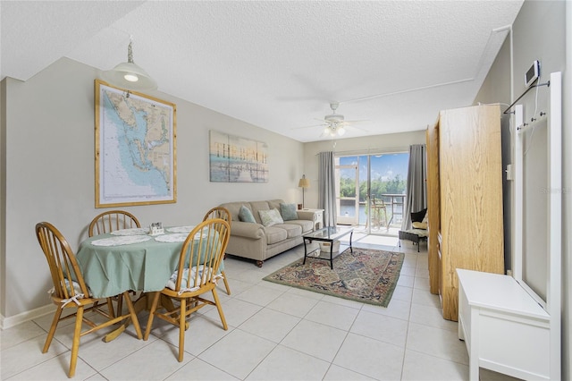 living room featuring light tile patterned floors, a textured ceiling, and ceiling fan