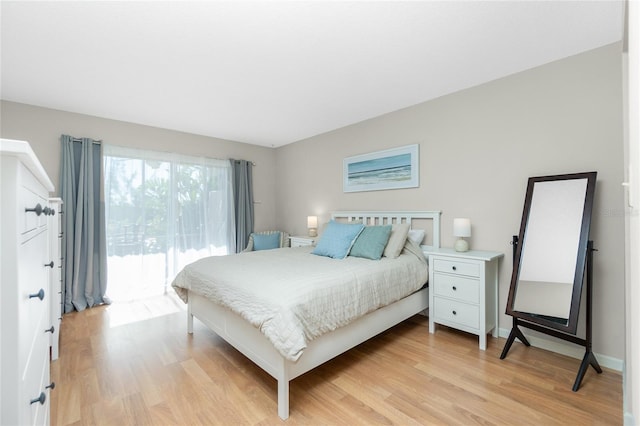 bedroom featuring light hardwood / wood-style floors and access to outside