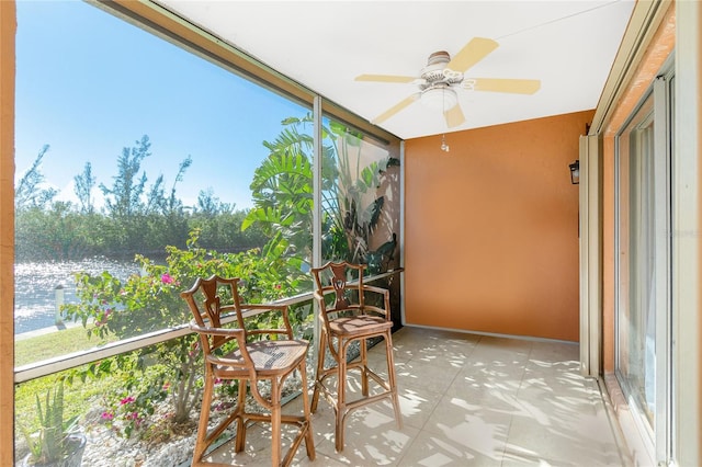 unfurnished sunroom with ceiling fan