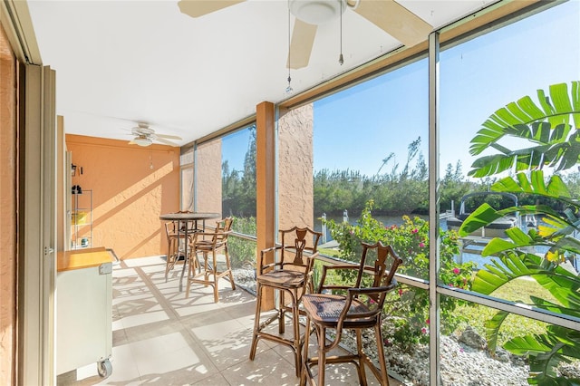 sunroom featuring ceiling fan