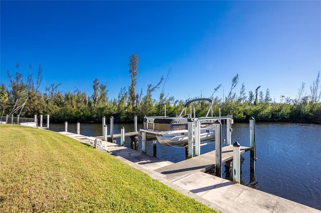 dock area featuring a yard and a water view