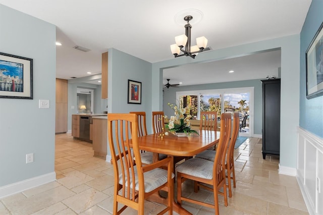 dining space with ceiling fan with notable chandelier