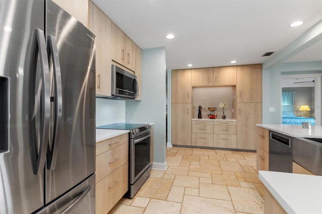 kitchen with light brown cabinets and stainless steel appliances