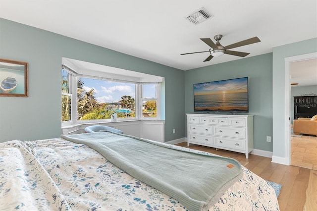 bedroom with ceiling fan and light hardwood / wood-style flooring