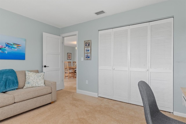 office area featuring light carpet