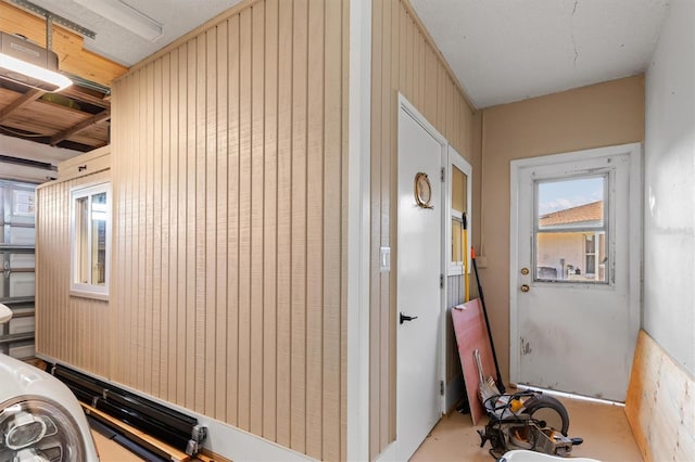 corridor featuring wooden walls