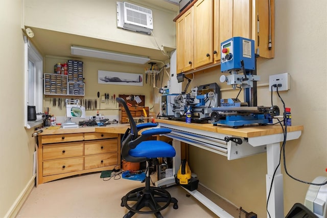 interior space with a workshop area and a wall mounted AC