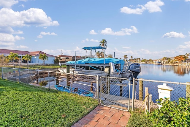 view of dock with a water view and a lawn