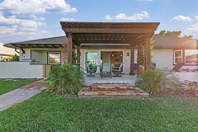 rear view of property with a lawn, a pergola, and a patio