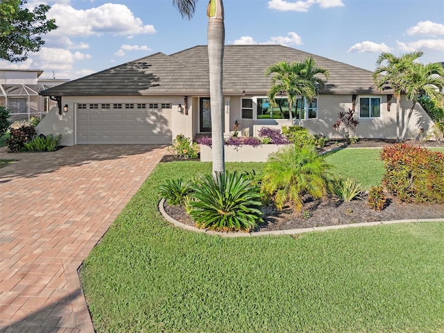 single story home featuring a garage and a front yard