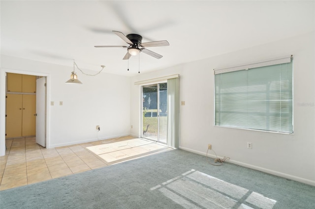 empty room with ceiling fan and light colored carpet