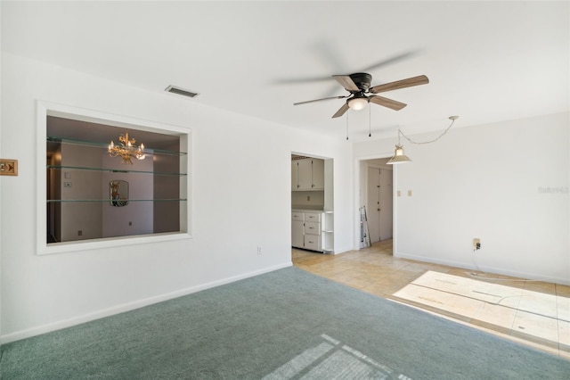 unfurnished room with ceiling fan with notable chandelier and light colored carpet