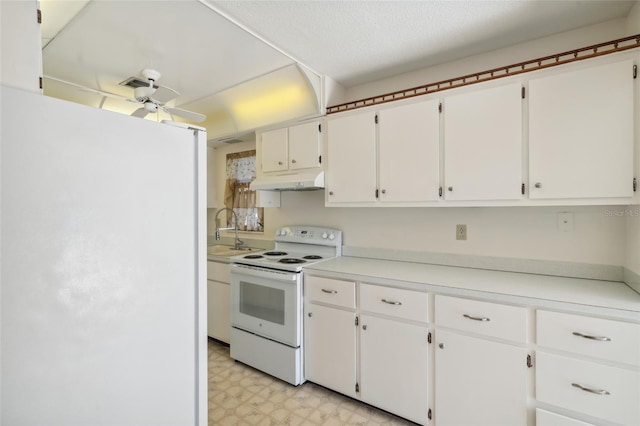 kitchen with white cabinets, white appliances, sink, and a textured ceiling