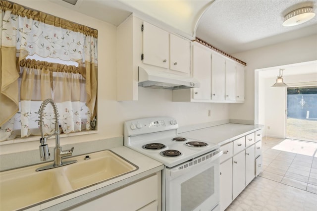 kitchen featuring a textured ceiling, sink, pendant lighting, white range with electric cooktop, and white cabinetry