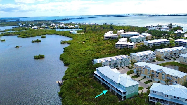 drone / aerial view featuring a water view and a residential view