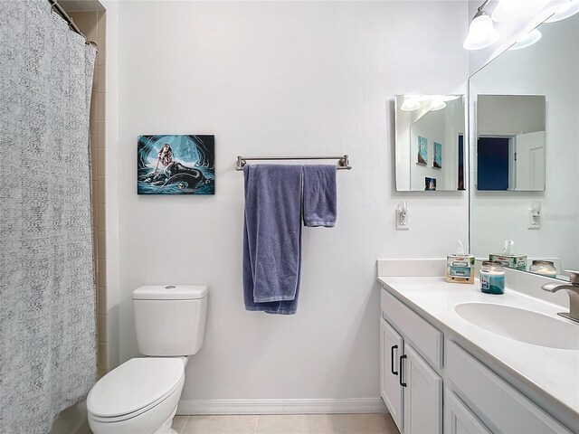 bathroom with vanity, baseboards, tile patterned flooring, curtained shower, and toilet