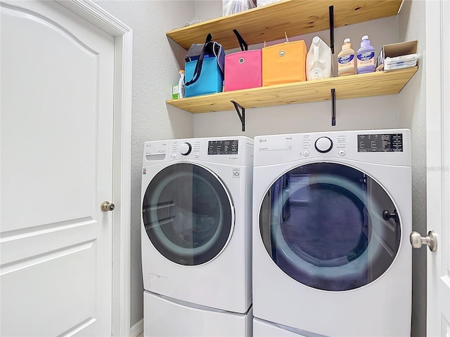 laundry area with washing machine and dryer and laundry area