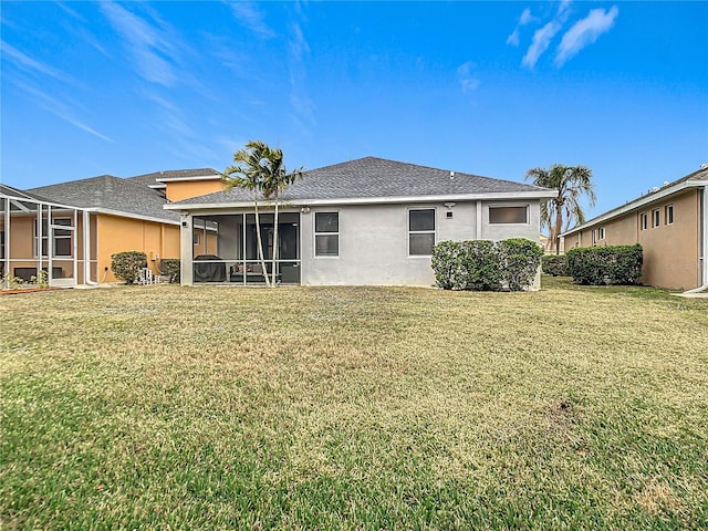 rear view of property featuring a yard and stucco siding