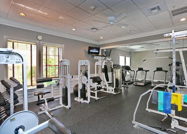 exercise room with a healthy amount of sunlight, visible vents, and ornamental molding