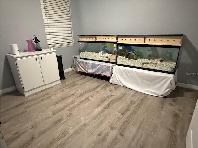 bedroom featuring baseboards and light wood-type flooring