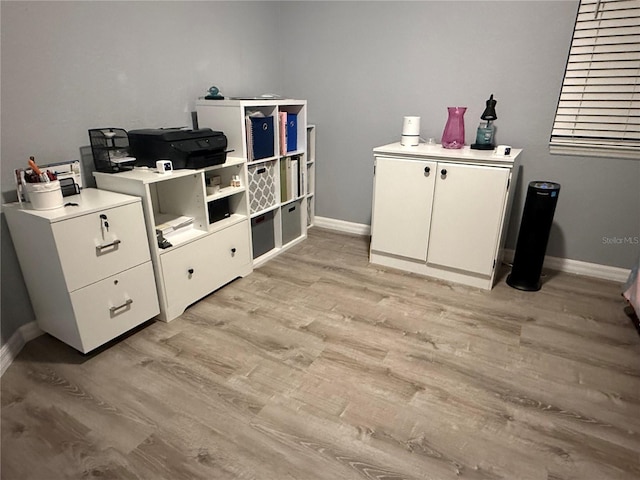 interior space featuring light wood-style flooring and baseboards